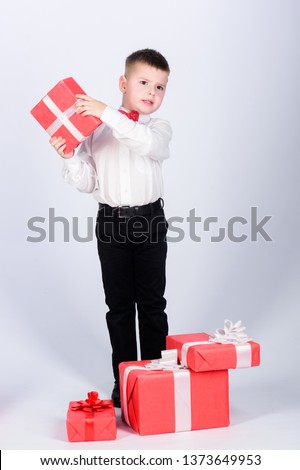 Cheerful shop assistant. happy child with present box. Christmas. little boy with valentines day gift. Birthday party. Shopping. Boxing day. New year. tuxedo style. Happy childhood.