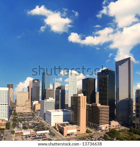 Majestic downtown Houston Texas skyline with wide open sky and clouds