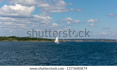 Water splash from moving boat and small yatch at distance Sweden