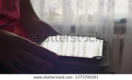 Young Woman uses digital tablet browsing internet and watching video on tablet PC with Point of view video footage of hands of anonymous woman and modern touchpad.