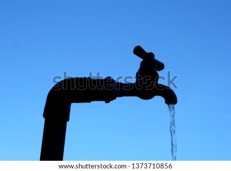  waste water. Tap water and pipes i n blue sky ,silhouette image.         