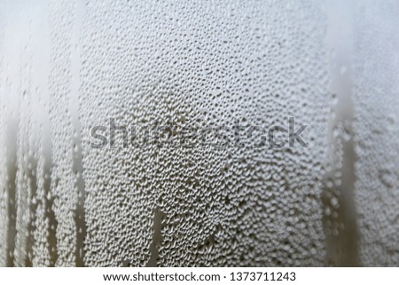 condensation drops on window glass. natural blurry abstract background. autumn mood