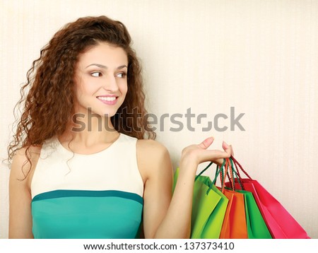 Young girl holding shopping bag, isolated on white background