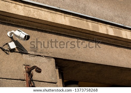 Two Video surveillance camera on location on background blue sky