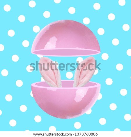 Bunny ears peeking out of pink sphere.