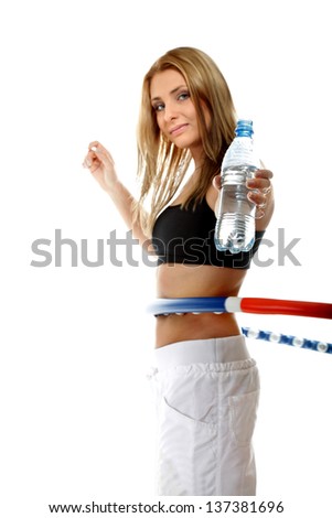 young sporty girl doing exercise with hula hoop drinking water. Fitness woman isolated on white