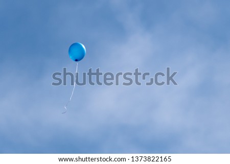 Blue Helium Filled Party Balloons Floating into Sky