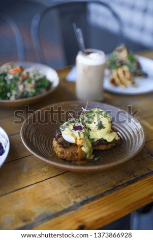 Eggs Benedict with poached eggs, potato fritters and barbequed pulled pork