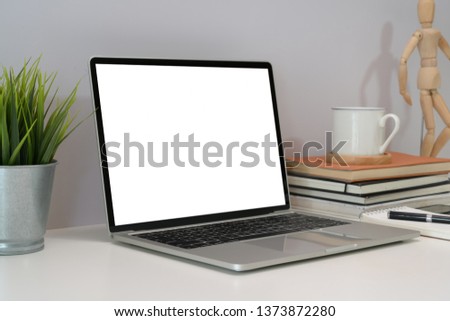 Blank screen laptop at workplace in office 