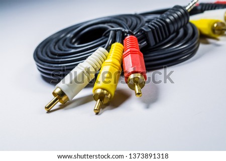 On white background hank of black cables with multi-colored plugs  tulip. Technologies. A multimedia wire for TV