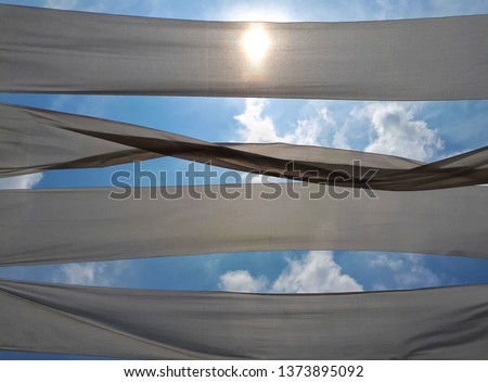 The decoration of the restaurant, white cloth in the sky, the wind blowing and the bright sunlight