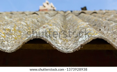 Dangerous asbestos roof. Asbestos dust in the environment. Health problems Royalty-Free Stock Photo #1373928938