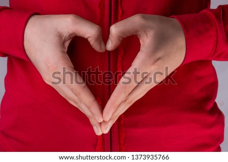 Hand making a heart on a white background