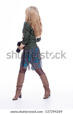 Beautiful blonde girl with a photo camera with glasses photographer rehearses photoshoot
