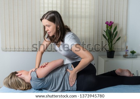 Blond Woman having chiropractic adjustment. Osteopathy, Alternative medicine, pain relief concept. Physiotherapy, sport injury rehabilitation. Royalty-Free Stock Photo #1373945780