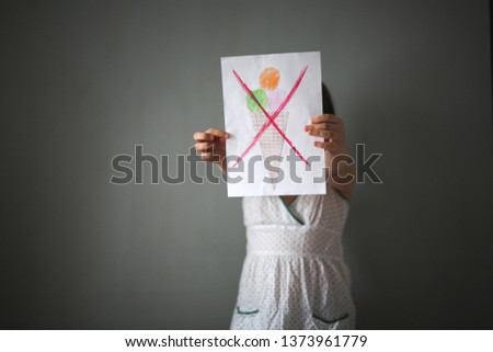 Ban on sweets, girl with a pattern with crossed ice cream, concept diet, rejection of sweet and healthy food