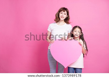 Happy mother's day! Mom and daughter showing love symbol