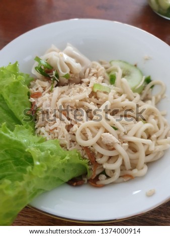 This is "Cwie Mie", Indonesia traditional food, made from noodles, minced chicken, lettuce and broth.