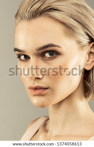 Young model. Portrait of a pleasant good looking woman while posing for a photo