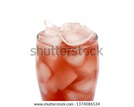 pieces of ice in a glass with natural fruit juice