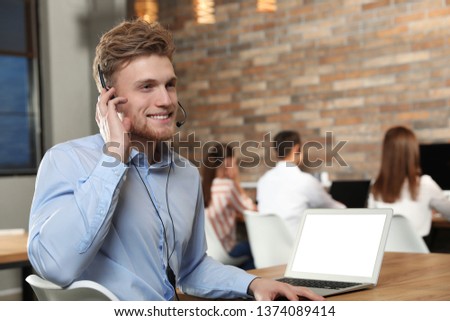Technical support operator with headset in modern office