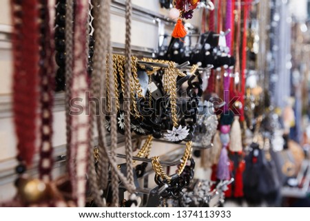 Image of colored  rivieres hanging on the stand in the store