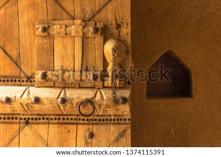 Image of a classical Arabic door from Riyadh, Saudi Arabia, capturing the traditional craftsmanship and design elements of the door, providing a glimpse into Riyadh's architectural history.