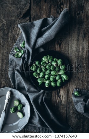  Dark and moody photography Brussels sprouts on a black plate on a dark wooden background