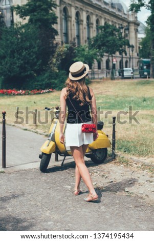 Portrait of summer girl on scooter. Fashion young blonde woman. vintage style image