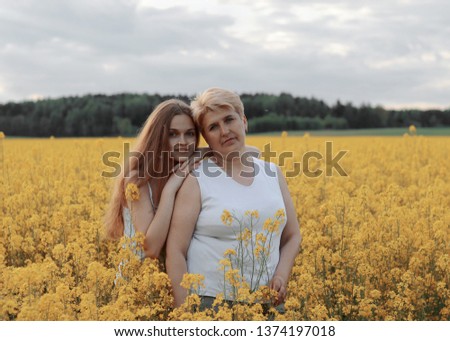 mother with daughter in a flower field
