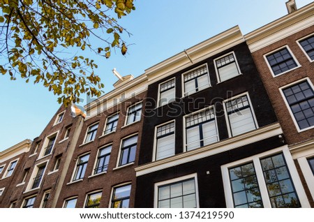 Amsterdam typical dutch house in streets of Damrak Holland Netherlands urban architecture facade travel Europe