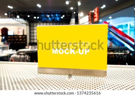 Mock up vertical blank signboard in acrylic frame with clipping path to show promotion or discount in shop clothing, yellow screen empty space for insert text or advertising in shopping mall