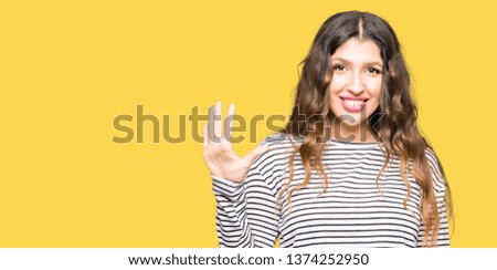 Young beautiful woman wearing stripes sweater showing and pointing up with fingers number five while smiling confident and happy.