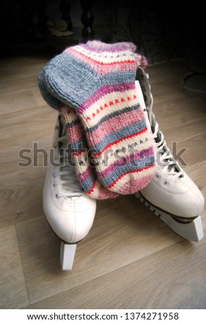 Striped knitted socks on figure skates