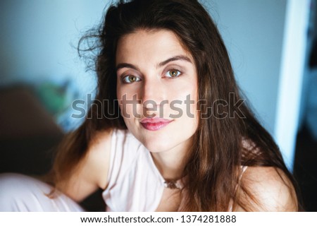 Portrait of a beautiful young woman with long hair.