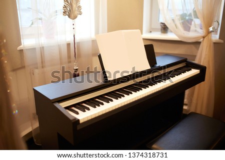 Old piano in the ancient house. The room is aged style. Interior of the home.