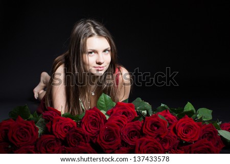 beautiful girl with roses on a black background