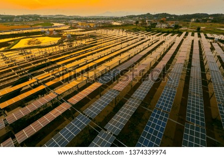 Aerial photography of solar photovoltaics built in the river pond under the sunset