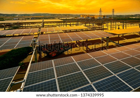 Aerial photography of solar photovoltaics built in the river pond under the sunset