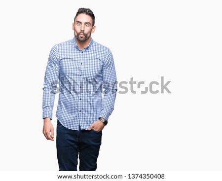 Young handsome man over isolated background making fish face with lips, crazy and comical gesture. Funny expression.