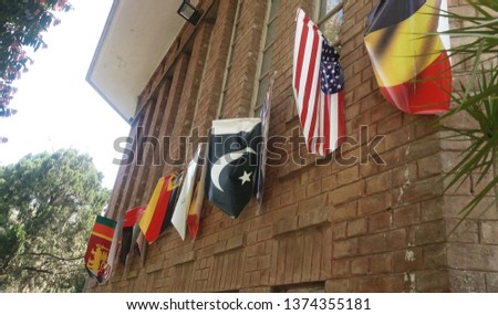 Its a picture of flags of different countries hanging on wall.