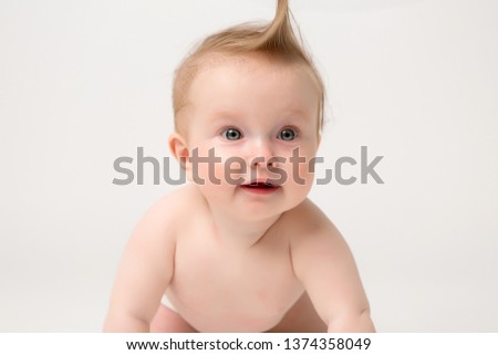 Cute little baby in diapers crawling on white background,bright picture of crawling curious baby over white backgroubd