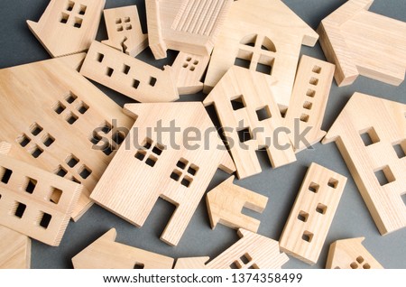 Many felled wooden houses. Destruction of houses as a result of natural disaster. The flood. Hurricane. Fire. Danger. Emergency housing. Reconstruction of old buildings. Evacuation of residents Royalty-Free Stock Photo #1374358499