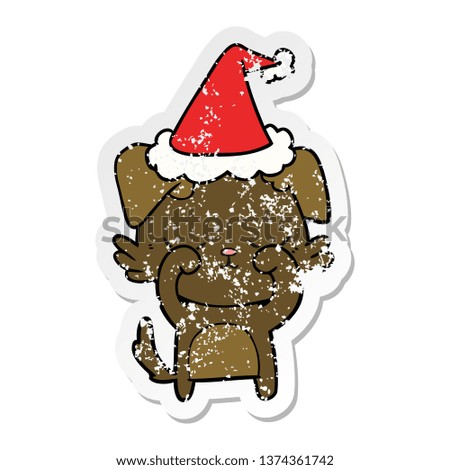 cute hand drawn distressed sticker cartoon of a dog wearing santa hat
