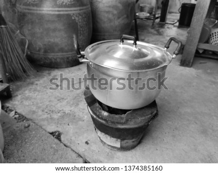 Big pot on​ traditional stove.​ Grayscale.