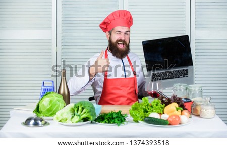 Chef laptop at kitchen. Culinary school. Hipster in hat and apron buy products online. Shopping online. Man chef searching online ingredients cooking food. Grocery shop online. Delivery service.