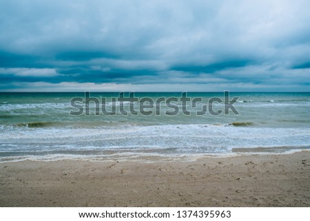 Windy storm beach sea waves with dark clouds