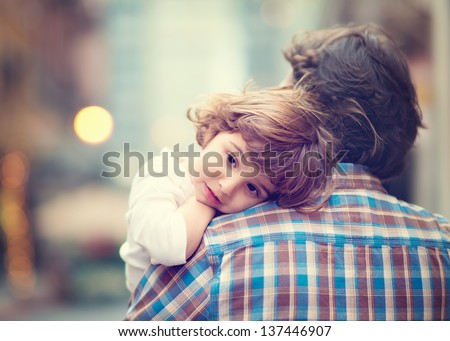 Little Girl resting on her father's shoulder Royalty-Free Stock Photo #137446907
