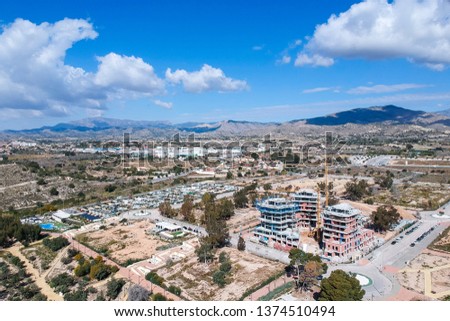 Construction site from a bird's eye view. View from above. Mountains and clouds. Photo from the drone. Building. Panorama from above.