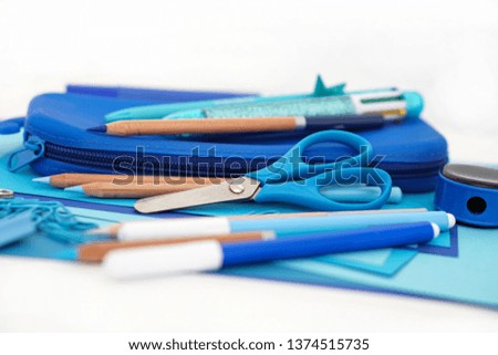 Stationery stack . Back to school. Paper sheets notepad pencils multicolor pen sharpener pencil case scissors . Frame composition with copy space Objects on white background                 